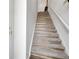 Staircase with combined carpet and hardwood treads and a white handrail at 4251 S Blackhawk Cir # 3E, Aurora, CO 80014