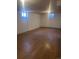 Large open basement with laminate floors and multiple windows providing natural light at 606 Tennyson St, Denver, CO 80204