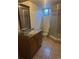 Basement bathroom featuring a shower, vanity, toilet, and tile flooring at 606 Tennyson St, Denver, CO 80204