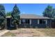Charming single-story home with gray siding, white trim, and mature landscaping at 606 Tennyson St, Denver, CO 80204