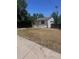 A detached garage with white siding and a single overhead door in a large grass backyard at 606 Tennyson St, Denver, CO 80204