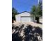 A detached one-car garage with white siding, concrete pad, and an overhead door at 606 Tennyson St, Denver, CO 80204