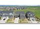 Suburban neighborhood featuring manicured lawns and sidewalks with easy access to nearby green spaces and roadways at 671 Green Mountain Dr, Erie, CO 80516