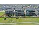 Aerial view of a home and landscaped backyard with fire pit and surrounding homes in neighborhood at 671 Green Mountain Dr, Erie, CO 80516