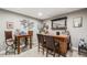 Finished basement bar featuring custom woodwork, seating and modern decor at 671 Green Mountain Dr, Erie, CO 80516