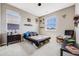 Bright bedroom with neutral walls, two windows, simple bed frame, and carpeted floors at 671 Green Mountain Dr, Erie, CO 80516