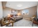 Spacious carpeted bedroom with a large window and neutral walls and warm lighting at 671 Green Mountain Dr, Erie, CO 80516
