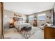 Spacious bedroom features carpet, a bed, two windows with neighborhood views, and wooden furniture at 671 Green Mountain Dr, Erie, CO 80516