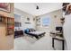Bright bedroom with neutral walls, two windows, simple bed frame, and carpeted floors at 671 Green Mountain Dr, Erie, CO 80516