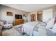 Bedroom features carpet, a bed, and a wooden dresser with a mounted television at 671 Green Mountain Dr, Erie, CO 80516
