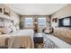 Bedroom with carpet, bed, neighborhood view, and wooden dresser with a mounted television at 671 Green Mountain Dr, Erie, CO 80516