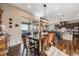 Dining room with wood table, chairs, wood floors, and sliding door access to outdoor patio at 671 Green Mountain Dr, Erie, CO 80516