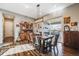 Stylish dining room features a wooden table set, hardwood floors, sliding glass doors, and a rustic hutch at 671 Green Mountain Dr, Erie, CO 80516