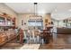 Open dining area boasts a wood table set, hardwood floors, and a view into the living room at 671 Green Mountain Dr, Erie, CO 80516