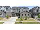 Charming two-story home featuring stone accents, a well-manicured lawn, and a welcoming facade at 671 Green Mountain Dr, Erie, CO 80516