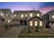 Charming two-story home with a well-manicured lawn, warm lighting, and a welcoming facade at 671 Green Mountain Dr, Erie, CO 80516