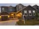 Charming two-story home with stone accents, a three-car garage, and inviting front entrance at 671 Green Mountain Dr, Erie, CO 80516