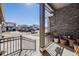 Inviting front porch with stone accent wall and iron railing, creating a cozy outdoor space at 671 Green Mountain Dr, Erie, CO 80516