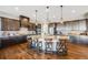 Spacious kitchen with dark cabinets, a large island, and modern pendant lighting at 671 Green Mountain Dr, Erie, CO 80516