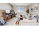 Comfortable living room with a large window offering scenic neighborhood views, a TV, and stylish decorations at 671 Green Mountain Dr, Erie, CO 80516