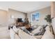 Comfortable living room with a large sectional sofa, scenic views, and neutral decor at 671 Green Mountain Dr, Erie, CO 80516