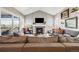 Cozy living room featuring a fireplace, hardwood floors, and mountain views at 671 Green Mountain Dr, Erie, CO 80516