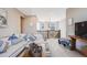 Inviting living room with a comfortable white sofa, decorative pillows, and view of the home's upper level at 671 Green Mountain Dr, Erie, CO 80516
