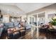 Open-concept living room with hardwood floors and sliding glass doors to the outdoor area at 671 Green Mountain Dr, Erie, CO 80516