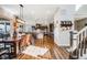 Open concept living space showcasing the kitchen, dining room, and Gathering room with dark wood flooring at 671 Green Mountain Dr, Erie, CO 80516