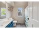 Well-lit bathroom featuring a modern vanity, toilet, and a shower with a stylish curtain at 7035 S Flower Ct, Littleton, CO 80128