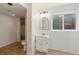 Functional bathroom featuring a walk-in shower, vanity with storage, and natural light from a window at 7035 S Flower Ct, Littleton, CO 80128