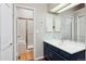 Clean bathroom featuring a vanity with blue cabinets, and a shower behind a glass door at 7035 S Flower Ct, Littleton, CO 80128