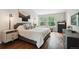 Serene bedroom with hardwood floors, a plush bed, and large windows with lots of natural light at 7035 S Flower Ct, Littleton, CO 80128