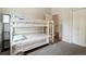 Cozy bedroom featuring a charming white bunk bed with fun patterned sheets and grey carpet at 7035 S Flower Ct, Littleton, CO 80128