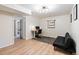 Bright bedroom features wood-look flooring, modern lighting, and versatile space for a home office or relaxing den at 7035 S Flower Ct, Littleton, CO 80128