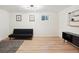 Bright bedroom features wood-look flooring, modern lighting, and versatile space for a home office or relaxing den at 7035 S Flower Ct, Littleton, CO 80128