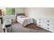 Bedroom features a twin bed, grey carpet, white dresser, and view of the outdoors at 7035 S Flower Ct, Littleton, CO 80128