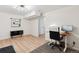 Bright bedroom features wood-look flooring, modern lighting, and versatile space for a home office or relaxing den at 7035 S Flower Ct, Littleton, CO 80128
