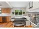 Dining area features a large table, bench seating, hardwood floors, and view of backyard at 7035 S Flower Ct, Littleton, CO 80128