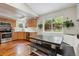 Dining area features a large table, bench seating, hardwood floors, and a view into the kitchen at 7035 S Flower Ct, Littleton, CO 80128