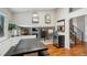 Dining area features a large table, bench seating, hardwood floors, and a view of a staircase at 7035 S Flower Ct, Littleton, CO 80128