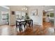 Cozy dining area with a modern table, hardwood floors, and plenty of natural light at 7035 S Flower Ct, Littleton, CO 80128
