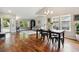 Dining room with hardwood floors, a large table, and view of the living area at 7035 S Flower Ct, Littleton, CO 80128