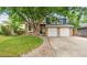 Charming two-story home with a manicured lawn, brick accents, and a two-car garage at 7035 S Flower Ct, Littleton, CO 80128
