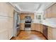 Bright kitchen features stainless steel appliances, light wood cabinets, and hardwood floors at 7035 S Flower Ct, Littleton, CO 80128