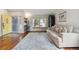 Bright living room with hardwood floors, a large window, and stylish furnishings at 7035 S Flower Ct, Littleton, CO 80128
