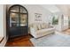 Bright living room featuring hardwood floors, a comfy sofa, and lots of natural light at 7035 S Flower Ct, Littleton, CO 80128