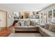 Cozy living room with view to kitchen, wood floors, and modern staircase at 7035 S Flower Ct, Littleton, CO 80128