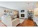 Inviting living room with fireplace, wood floors, and comfortable seating area at 7035 S Flower Ct, Littleton, CO 80128