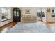 Cozy living room featuring hardwood floors, a comfortable sofa, and natural light at 7035 S Flower Ct, Littleton, CO 80128
